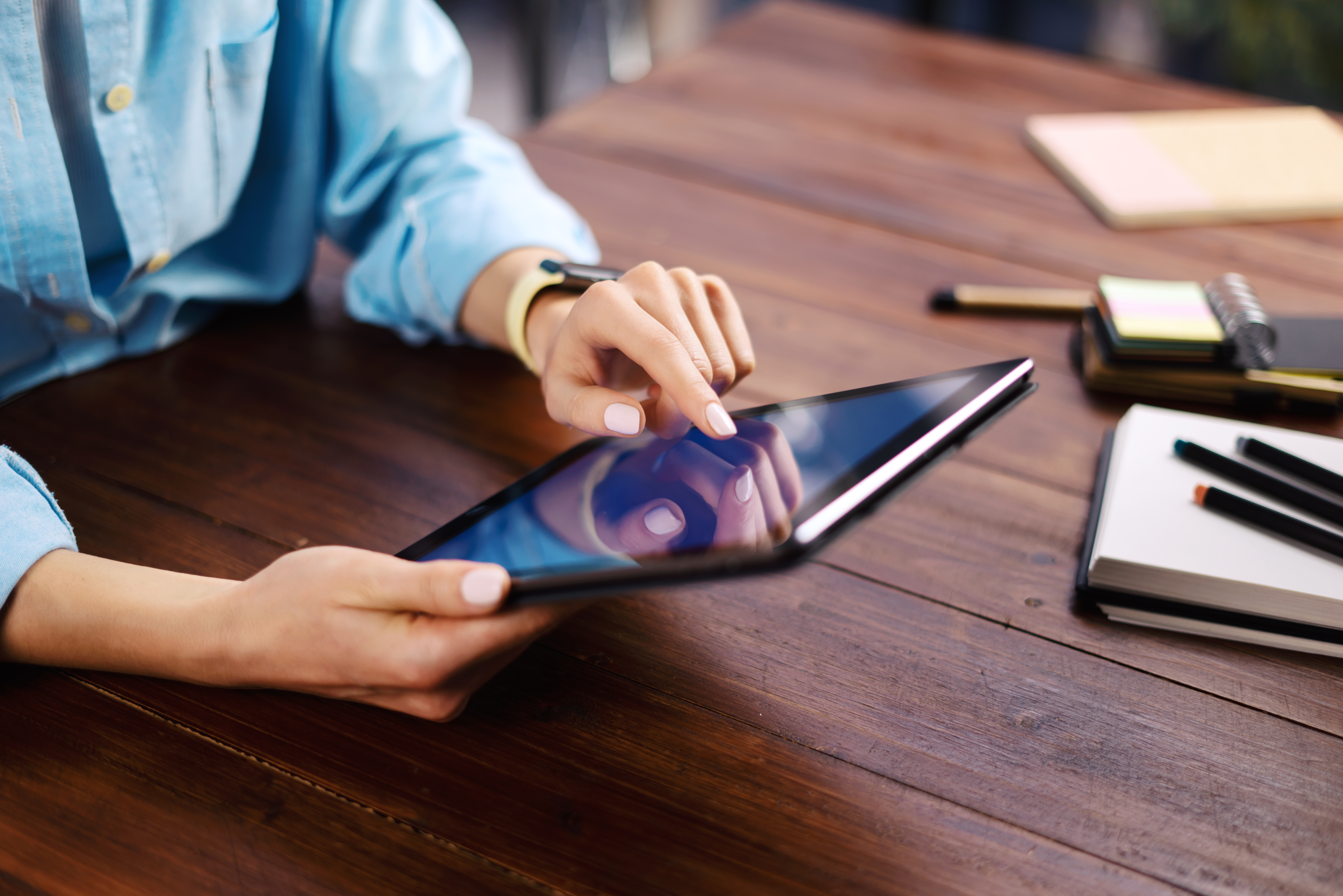 Woman pointing on digital tablet screen, chatting in social netw
